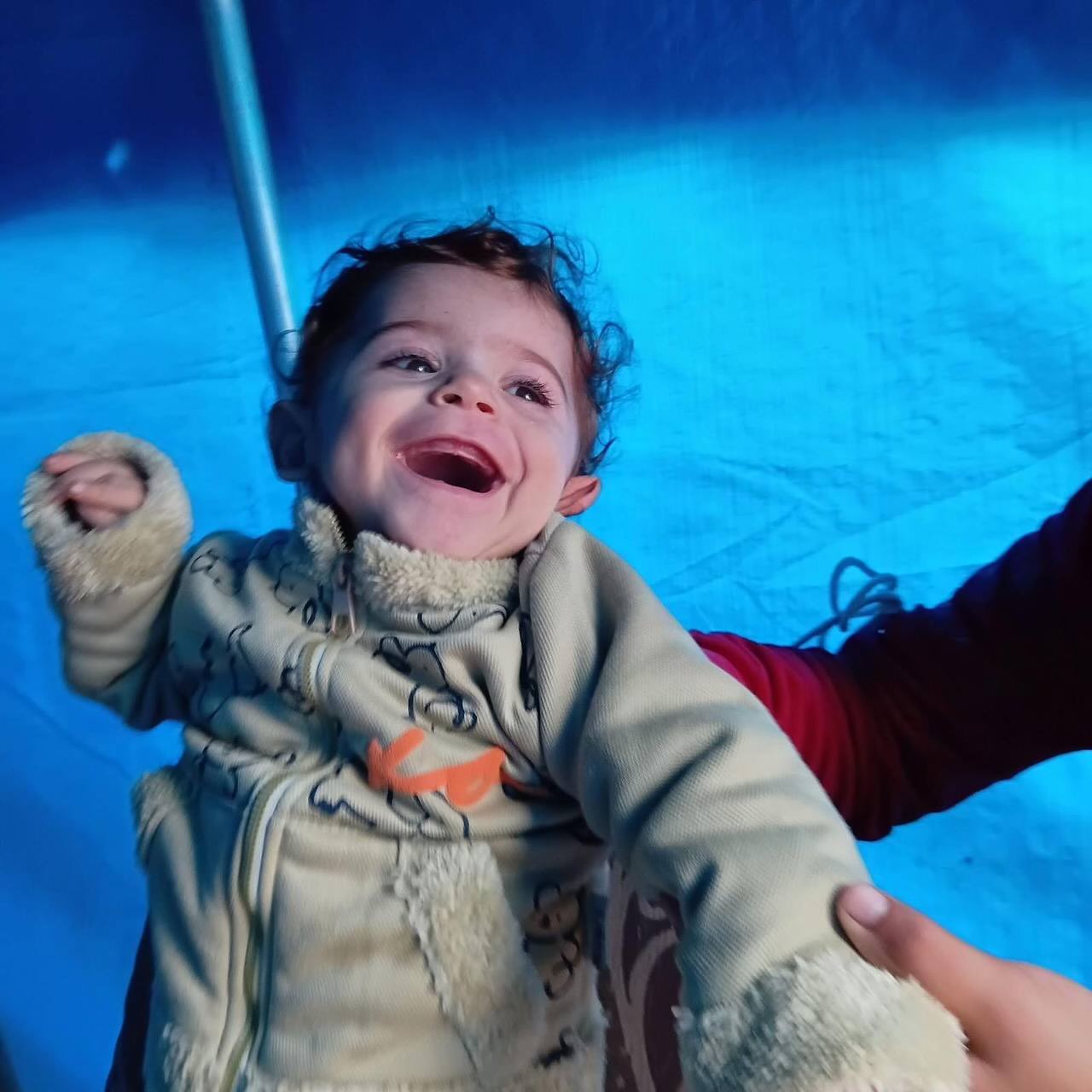 The one-year-old kid Muhammad El-Basiony froze to death in his torn-out tent.
